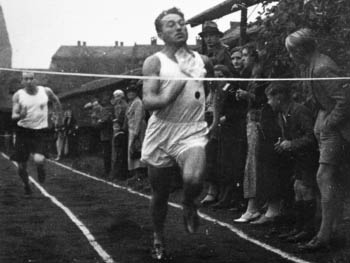 picture of Adi Dassler, founder of Adidas, as a running athlete in 1915, approaching the finished line